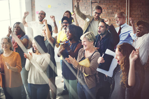 A group of excited employees cheering